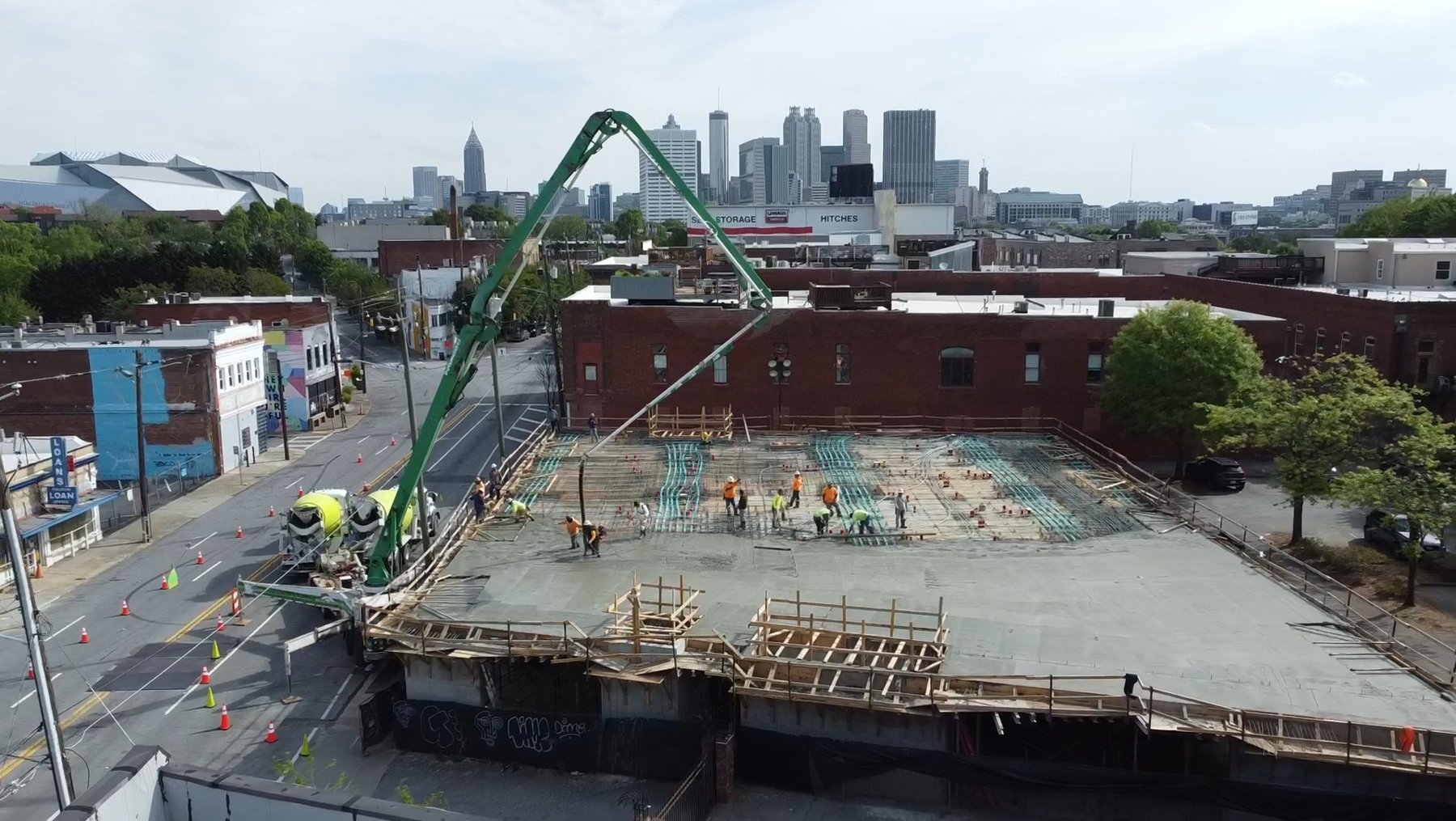 Lyric Lofts condos podium pour with the Atlanta skyline